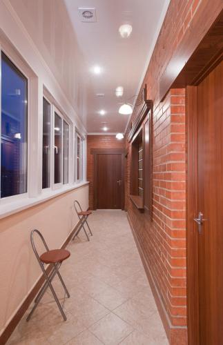 a hallway with two chairs and a brick wall at 7 Sky Hotel Klinicheskaya Street (2d entrance) in Kyiv