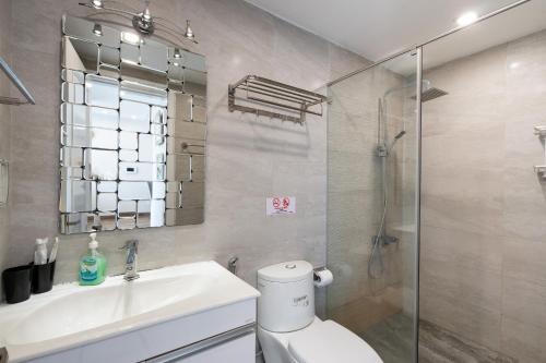 a bathroom with a toilet and a sink and a shower at Olala Saigon Apartment - Rivergate Residence in Ho Chi Minh City