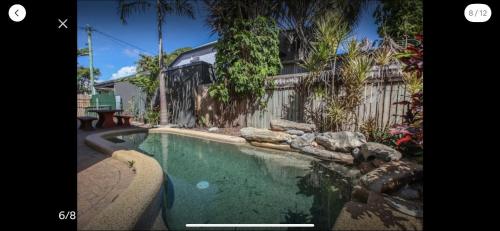 a swimming pool in front of a house at Grimshaw House in Cairns