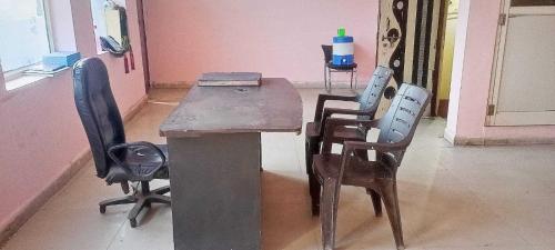 a wooden table and chairs in a room at OYO Hotel Dream Connect in Gwalior