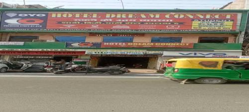 a building with cars and motorcycles parked in front of it at OYO Hotel Dream Connect in Gwalior