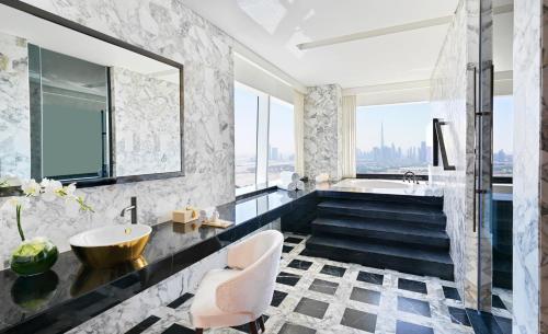 a bathroom with a tub and a sink at Sofitel Dubai The Obelisk in Dubai