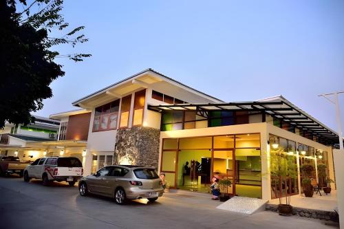 a car parked in front of a building at Delio Boutique Hotel in Udon Thani