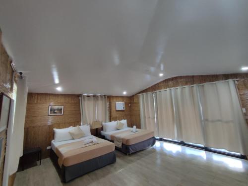 a large room with two beds and a couch at Caliraya Mountain Lake Resort in Cavinti