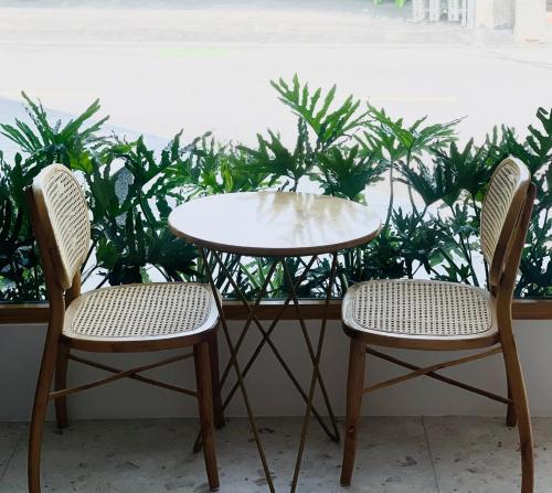 two chairs and a table and a table and two chairs at HOLIDAY HOTEL PHAN THiẾT in Ấp Bình Hưng