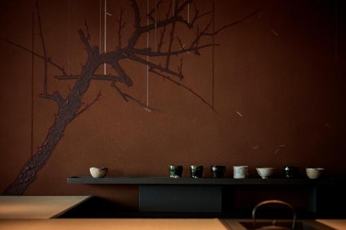 a wall with a picture of a tree on it at The Royal Park Hotel Iconic Nagoya in Nagoya
