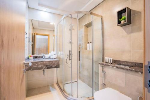 a bathroom with a shower and a toilet and a sink at Furnished 1 bhk in business bay in Dubai