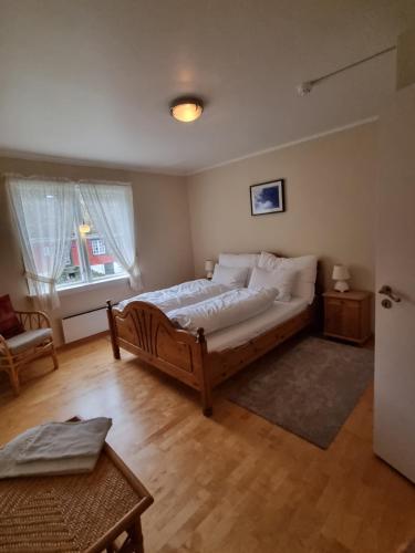 a bedroom with a large bed in a room at Rekkedal Gjestehus , Sæbø in Ørsta