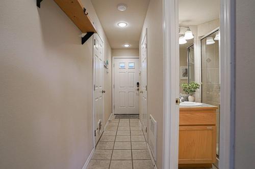 a hallway of a bathroom with a sink and a mirror at Ballard's Townhome with office & walk score 98 in Seattle