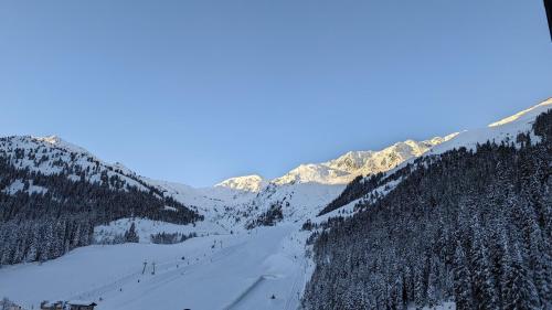 a snow covered mountain with a ski slope at Hotel Almhof in Hochfugen