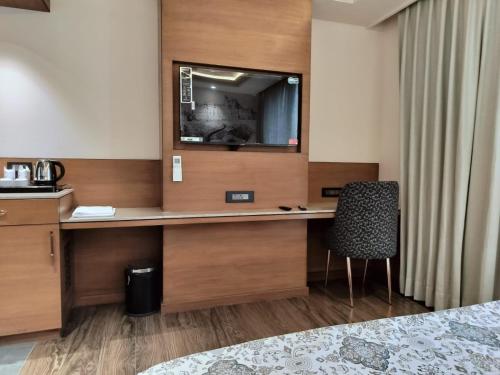 a desk in a hotel room with a mirror at Hotel Royal Lakshmi Palace in Jaipur