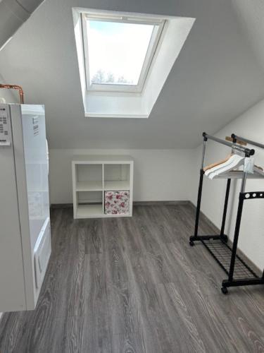an attic room with a skylight and a floor at Appartement 6 in Hilter in Hilter am Teutoburger Wald