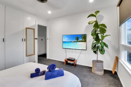 a bedroom with a bed and a flat screen tv at Sherbourne Retreat in Newtown in Geelong