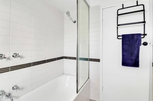 a bathroom with a shower with a glass door at Sherbourne Retreat in Newtown in Geelong