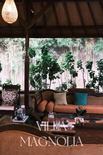a living room with a couch and a table at Villia magnolia sanur bali 巴厘島玉蘭別墅 in Denpasar
