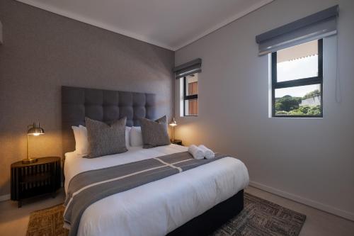 a bedroom with a large bed and a window at The Tyne Luxury Apartments in Durban