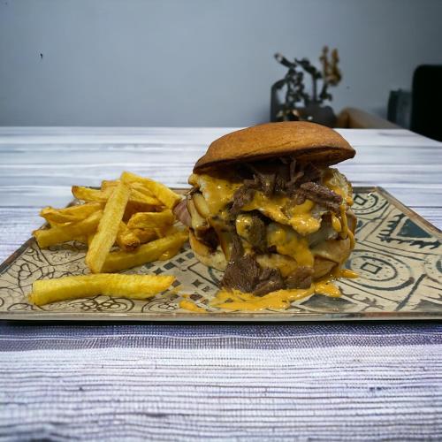 a sandwich and french fries on a plate at Hostal Restaurante La pinta in Ampuero