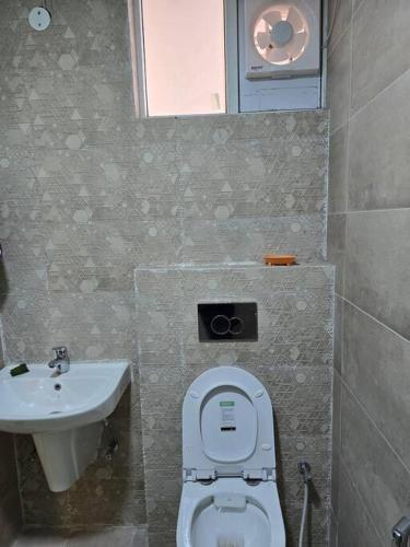 a bathroom with a toilet and a sink at Kimaya's Abode in Chandīgarh
