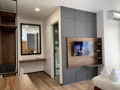 a room with a television on a wall at The RiverKwai Bridge Resort 2 in Ban Chuk Kum