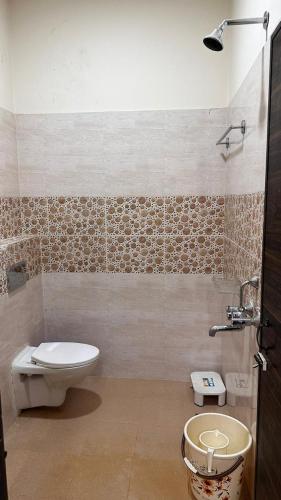 a bathroom with a toilet and a sink at Long Acres in Guwahati