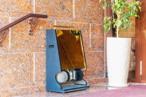 a machine sitting next to a brick wall at Praga Hotel in Tashkent