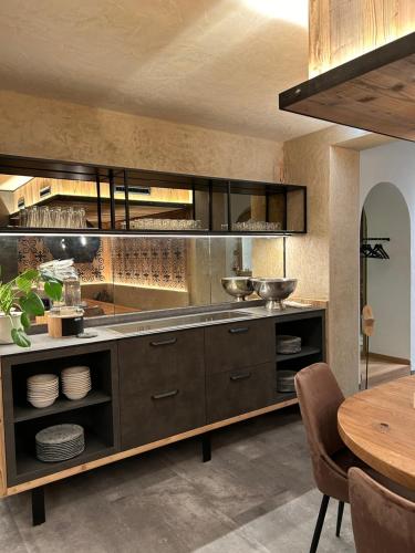 a kitchen with a counter with dishes on it at Pension Kreuzeck - Dein Glücksplatz am Lech in Weissenbach am Lech