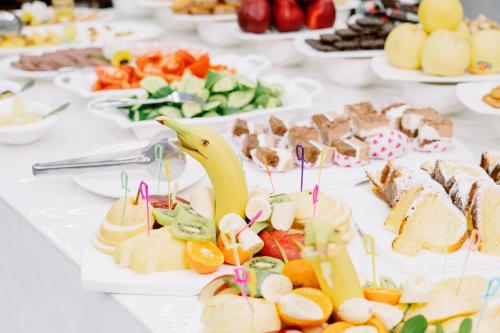 a table with many plates of food on it at PGA Hotel Free Shuttle to Airport in Tashkent