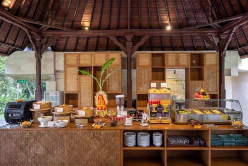 a kitchen with a counter with food on it at Santi Mandala Villa & Spa in Sukawati