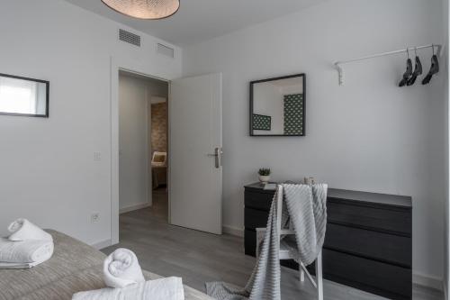 a bedroom with a bed and a desk and a mirror at tuGuest Santa Paula III Apartment in Granada