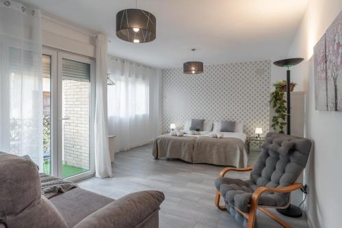 a living room with a bed and a couch at tuGuest Santa Paula III Apartment in Granada