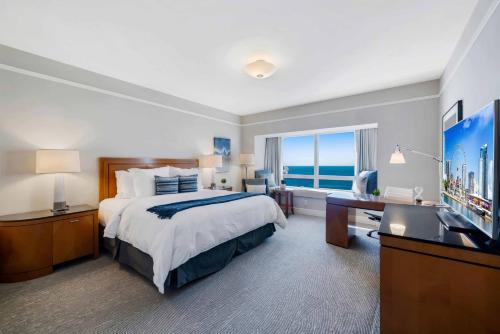 a large hotel room with a bed and a television at Casiola Residences at Four Seasons Miami Brickell in Miami