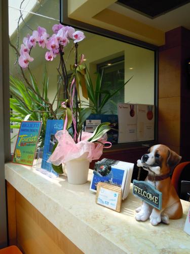 a dog figurine sitting on a counter in a store at Beach Hotel Du Lac Malcesine in Malcesine