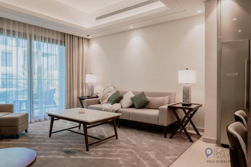 a living room with a couch and a table at Capital Stay- Private Two Bed Apartment - The Address Beach Resort Residences Fujairah in Fujairah