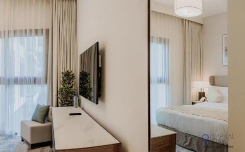 a bedroom with a bed and a mirror at Capital Stay- Private Two Bed Apartment - The Address Beach Resort Residences Fujairah in Fujairah