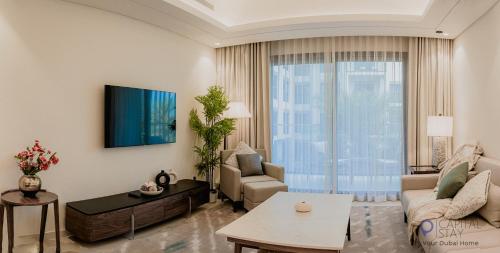 a living room with a couch and a table at Capital Stay- Private Two Bed Apartment - The Address Beach Resort Residences Fujairah in Fujairah
