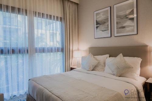 a bedroom with a large bed and a large window at Capital Stay- Private Two Bed Apartment - The Address Beach Resort Residences Fujairah in Fujairah