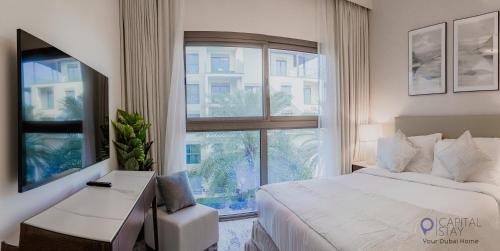 a bedroom with a bed and a large window at Capital Stay - 2 Bed Apartment- The Address Fujairah in Fujairah