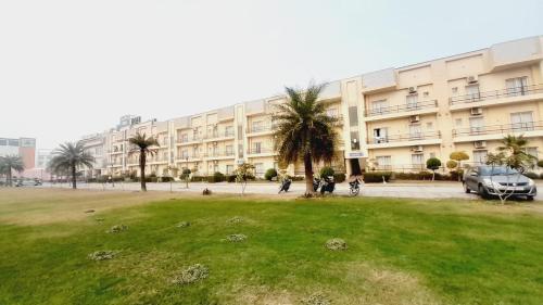 a large building with a park in front of it at Amber suits and Hotal in Vrindāvan