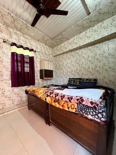 a bedroom with a bed in a room at ASTHA GUEST HOUSE in Gopeshwar