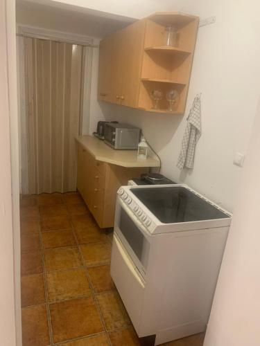 a kitchen with a stove and a microwave at Central and affordable room in basement in Krakow
