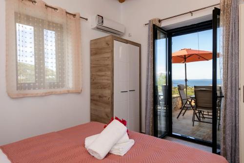 a bedroom with a bed and a view of the ocean at Mani's Best Kept Secret - Seaview Villa Lida in Agios Nikolaos