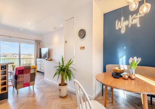 a dining room and living room with a table and chairs at Wye Knot - Boutique 2 Bedroom Town House in Wilton