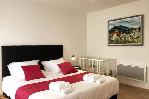 Cette chambre comprend 2 lits avec des oreillers rouges et blancs. dans l'établissement A l'ombre du Saule. Villa 10 personnes + piscine, à Saint-Romain-en-Viennois