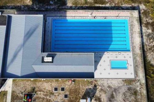 an overhead view of a building with a swimming pool at Double Seven Eight Homestay SemiD at Bandar Baru Setia Awan Perdana in Sitiawan