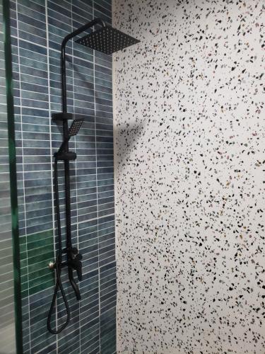 a shower in a bathroom with a glass door at The Mons inside Tower Regency Hotel and Apartments in Ipoh