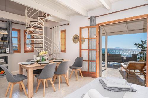 a kitchen and dining room with a table and chairs at Southbank seafront apartments in Katelios