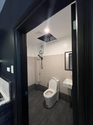 a bathroom with a toilet and a sink at Clark CU Hotel in Angeles