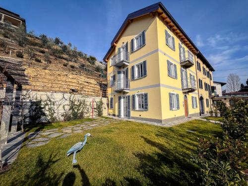 a bird standing on the grass in front of a building at RIAREL- Foresteria Lombarda in Rodero