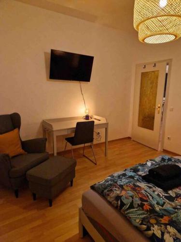 - un salon avec un lit et un bureau avec une chaise dans l'établissement Avali, à Bochum