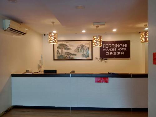 a bar in a room with a sign on the wall at FERRINGHI PARADISE HOTEL in Batu Ferringhi